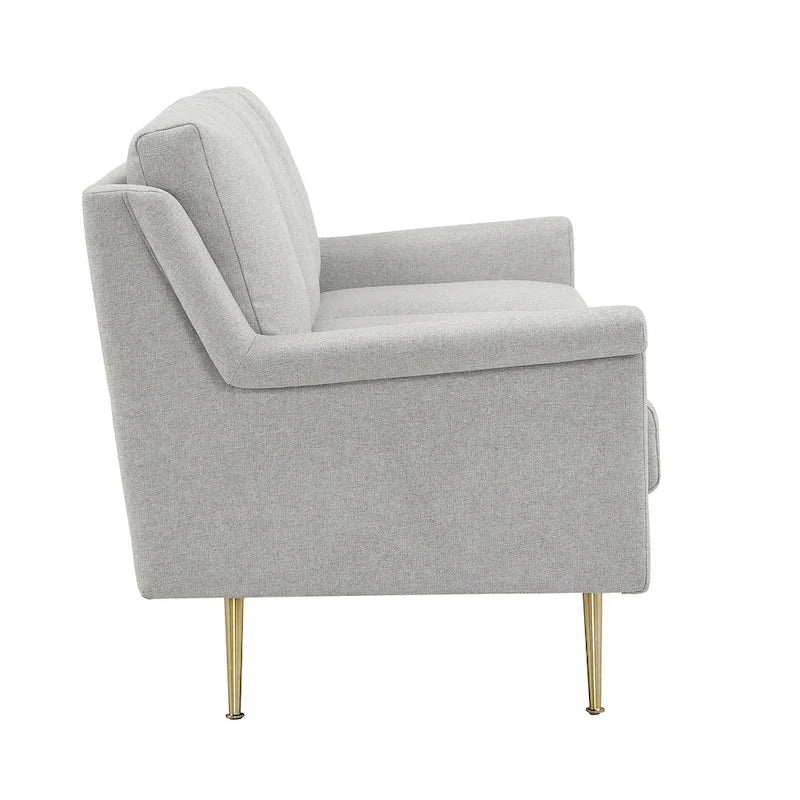 Szara sofa z materiału ze złotymi metalowymi nogami
